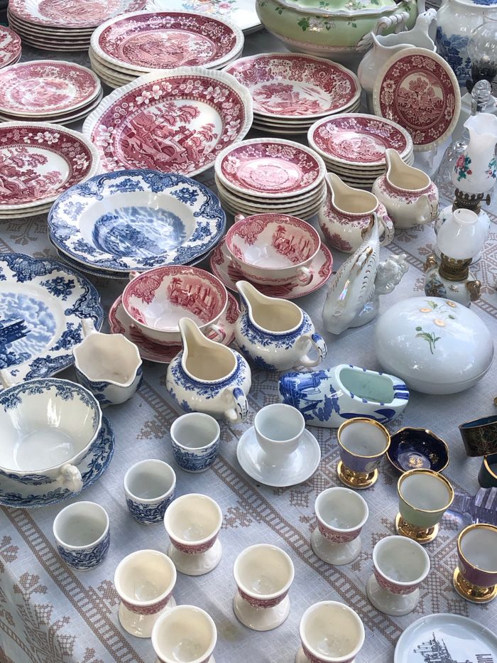 our-mission-01 An assortment of antique porcelain plates and cups in various colors and patterns on display.